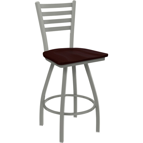 A Holland Bar Stool Jackie Ladderback Swivel Bar Stool with a dark cherry oak seat and an anodized nickel frame.