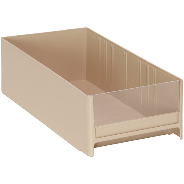 A beige plastic drawer for industrial storage with a clear bottom and lid.