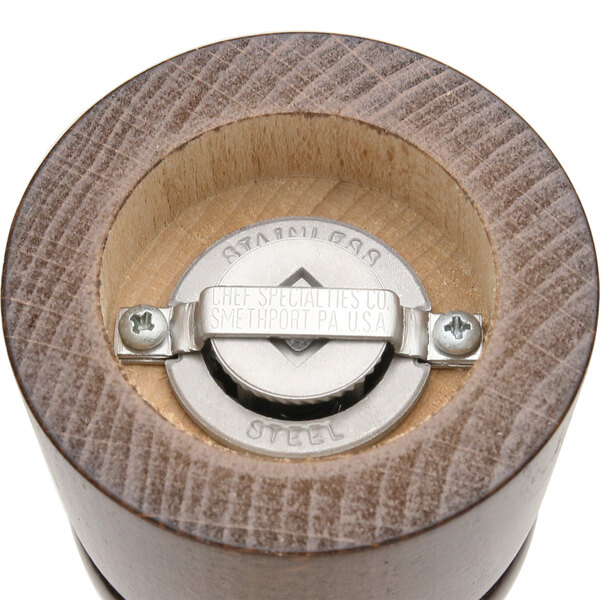 A close-up of a Chef Specialties Windsor Walnut pepper mill with a metal lid.