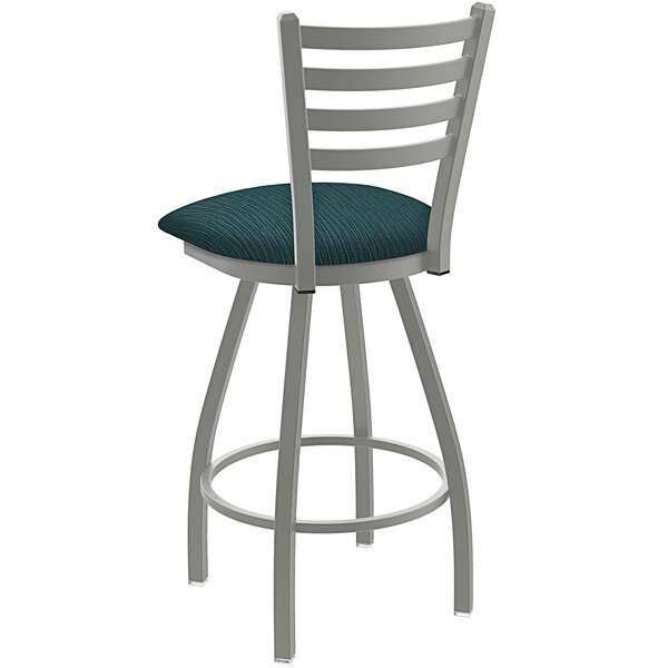 A white Holland Bar Stool ladderback swivel counter stool with a blue cushion.