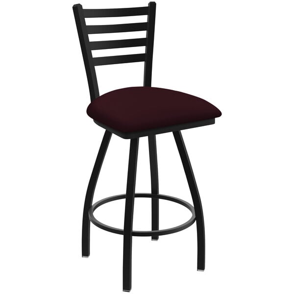 A black Holland Bar Stool ladderback swivel bar stool with a red cushion with black and red stripes.