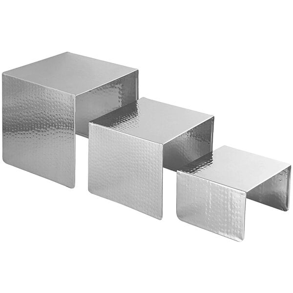 A Spring USA Xcessories 3-piece metal nesting display riser set with a hammered silver finish.