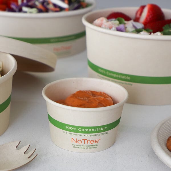 A small 4 oz. compostable portion cup made from NoTree material, shown with a sauce inside.