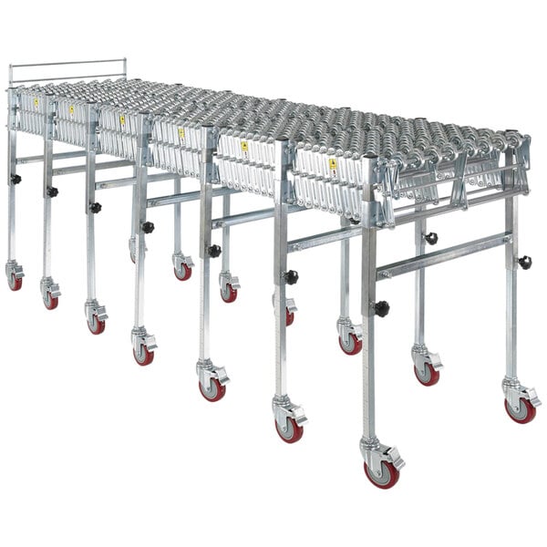 An aluminum and steel expandable conveyor with four rows of wheels.