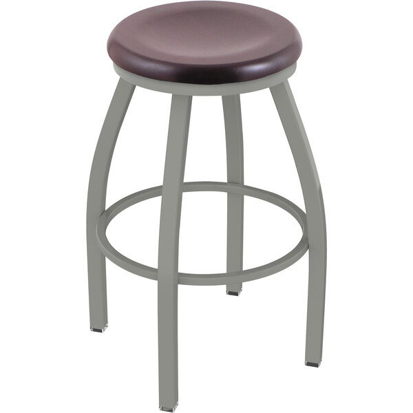 A Holland Bar Stool Misha Ladderback Swivel Bar Stool with a dark cherry maple seat.