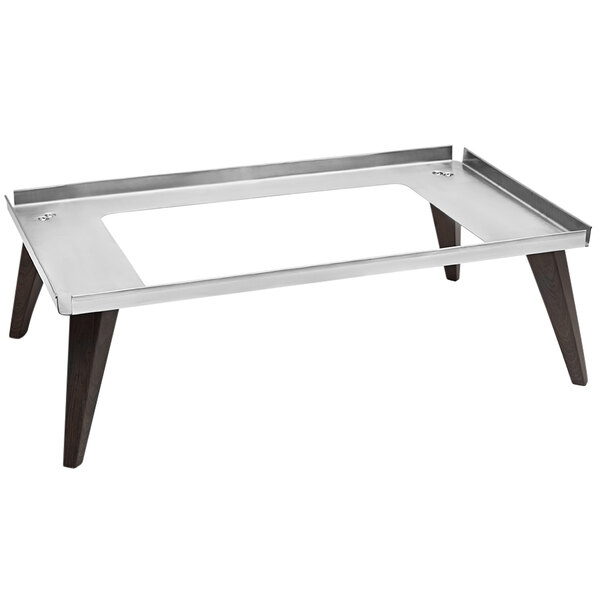 A Spring USA stainless steel and faux wood display stand on a metal table with wooden legs.