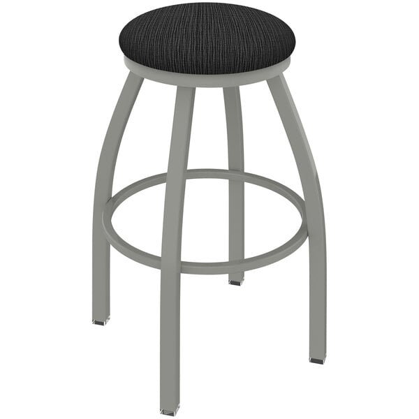 A grey Holland Bar Stool Misha Ladderback Swivel Bar Stool with a Graph Coal seat.