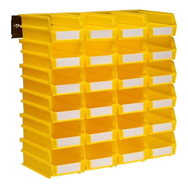 A yellow wall storage bin with compartments filled with white paper.