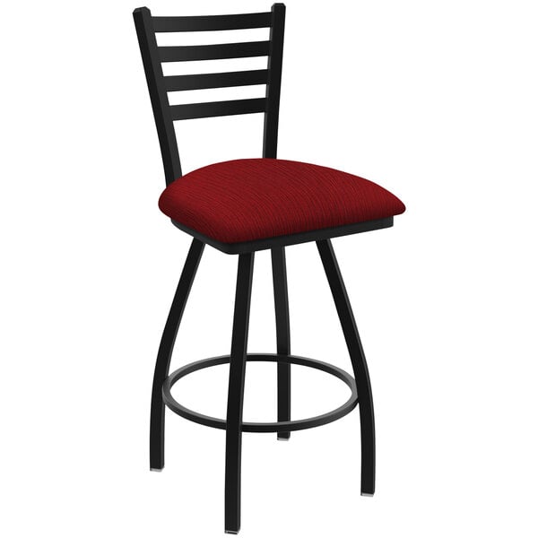 A Holland Bar Stool Jackie Ladderback swivel bar stool with black wrinkle finish and a red cushion with a graph pattern.