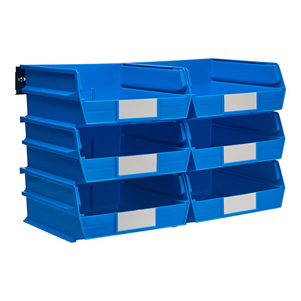 A white louvered panel with blue plastic bins and silver rails filled with white-labeled blue plastic bins.