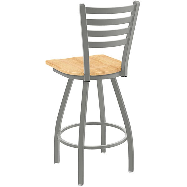 A Holland Bar Stool ladderback counter stool with a wooden seat and metal back.