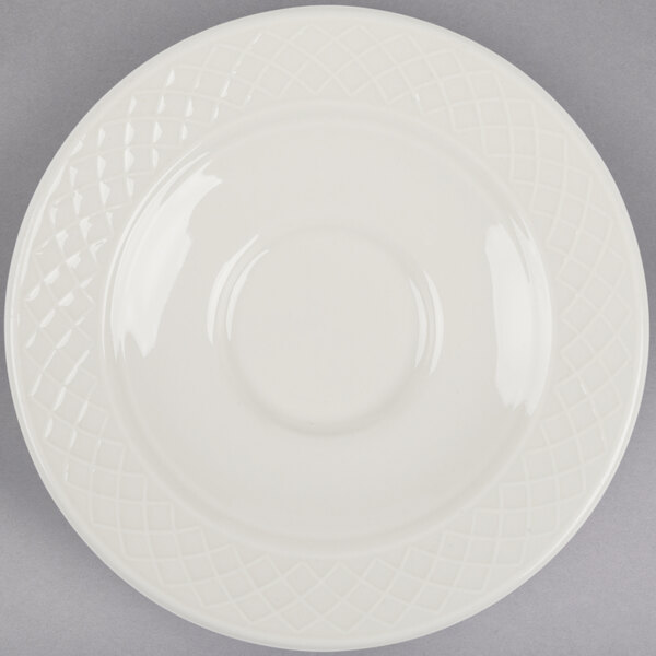 An ivory Homer Laughlin saucer with a circular design.