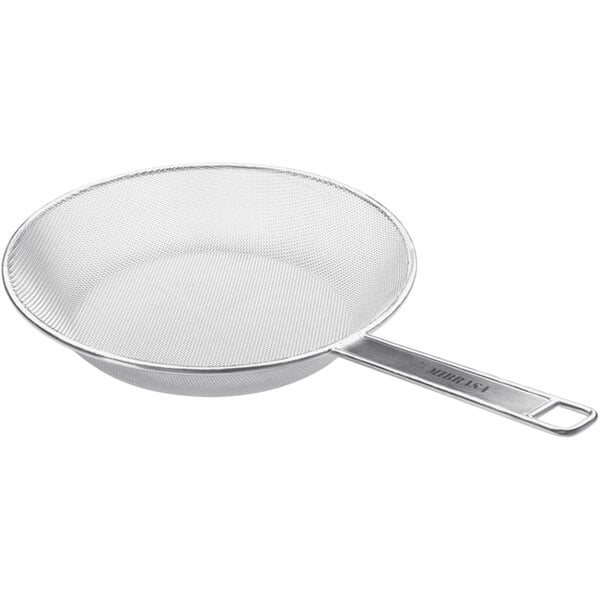 A Mibrasa stainless steel mesh grill pan with a handle.