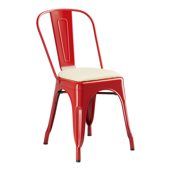 A red metal Lancaster Table & Seating cafe chair with a white cushion.