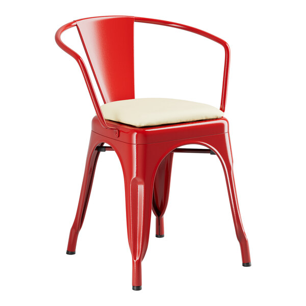 A Lancaster Table & Seating red metal arm chair with a white cushion.