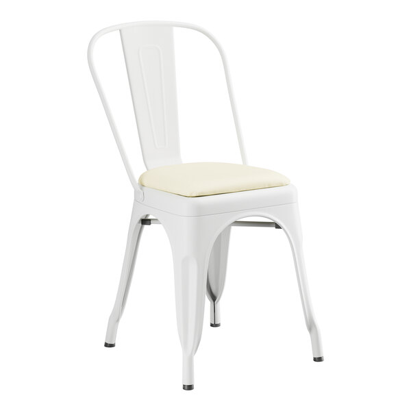 A white Lancaster Table & Seating metal cafe chair with a white cushion.