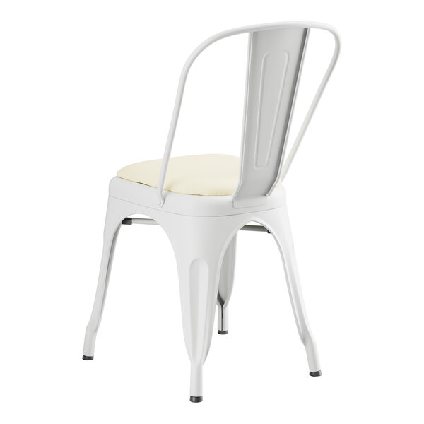 A Lancaster Table & Seating white metal cafe chair with white vinyl cushion.