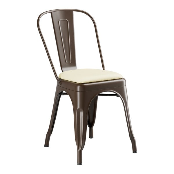 A brown metal Lancaster Table & Seating cafe chair with a white cushion.