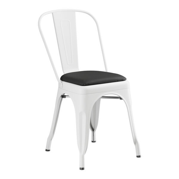 A Lancaster Table & Seating white metal cafe chair with black cushion.