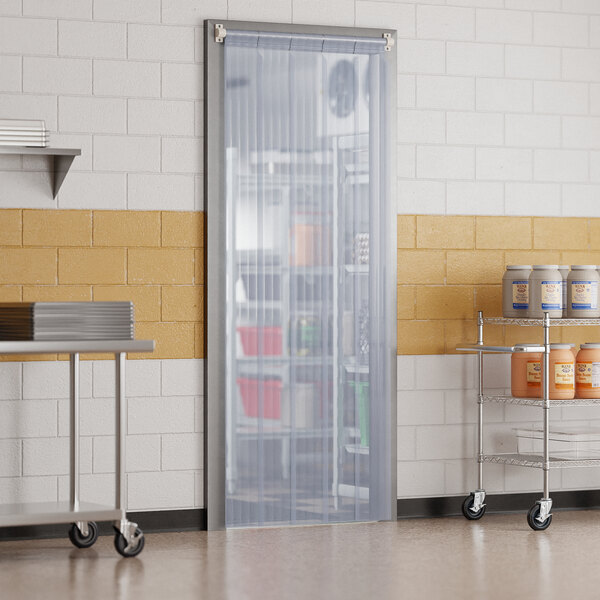 A room with a Curtron Polar Reinforced Strip Door on shelves.