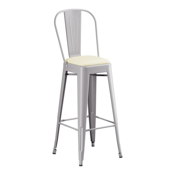 A Lancaster Table & Seating gray metal barstool with a white cushion