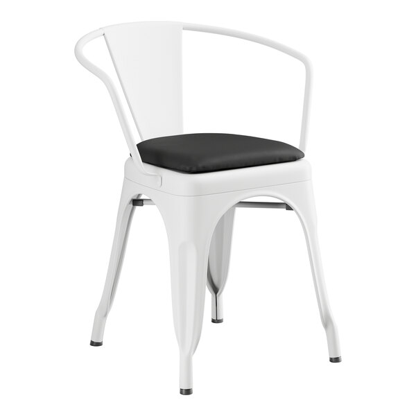A Lancaster Table & Seating white metal arm chair with black cushion.