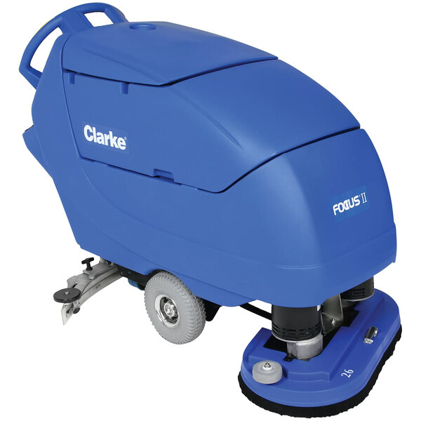 A blue Clarke Focus II cordless walk behind disc floor scrubber with wheels.