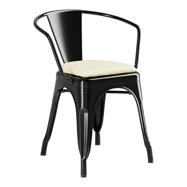 A Lancaster Table & Seating black metal arm chair with a white cushion.