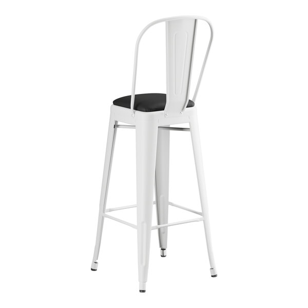 A Lancaster Table & Seating white metal cafe barstool with black cushion.