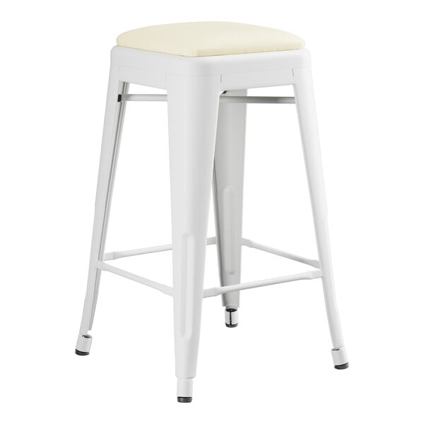A white Lancaster Table & Seating backless counter height stool with a white cushion