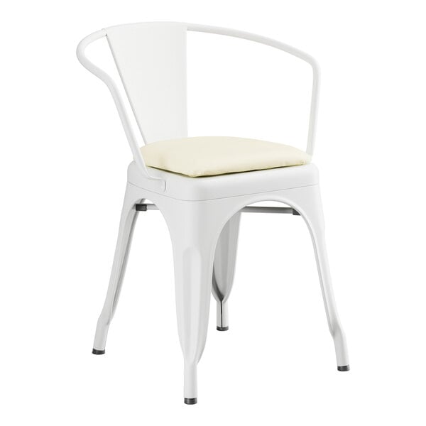 A Lancaster Table & Seating white metal arm chair with a white cushion.