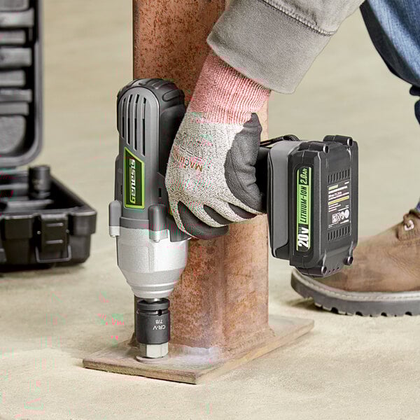 A person using the Genesis 20V Lithium-ion impact wrench to fix a metal pole.
