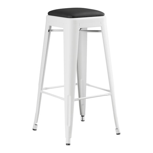 A Lancaster Table & Seating Pearl White metal barstool with black seat.