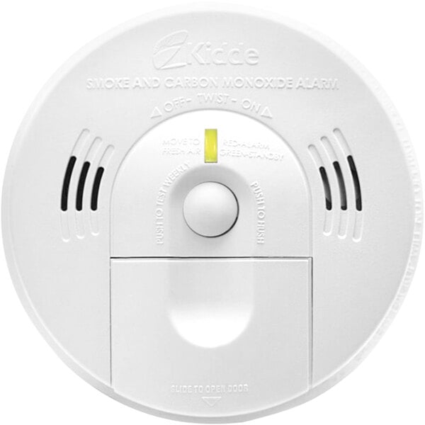 A white circular Kidde smoke and carbon monoxide alarm with a round button.