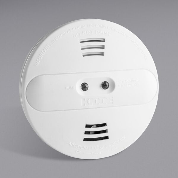 A white Kidde dual sensor smoke alarm with two holes.