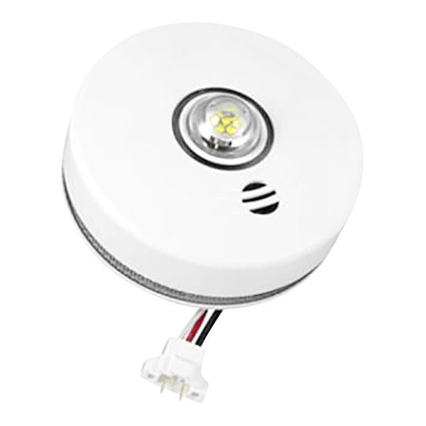 A white Kidde hardwired smoke alarm with a round hole and wires.