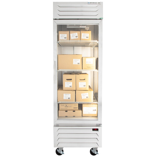A white Beverage-Air reach-in refrigerator with boxes on shelves.