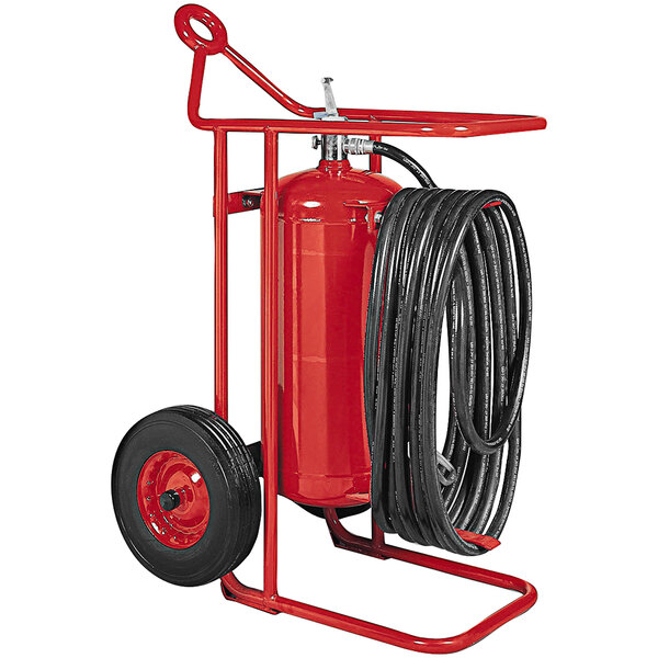 A Badger red fire extinguisher with a black hose on a cart.