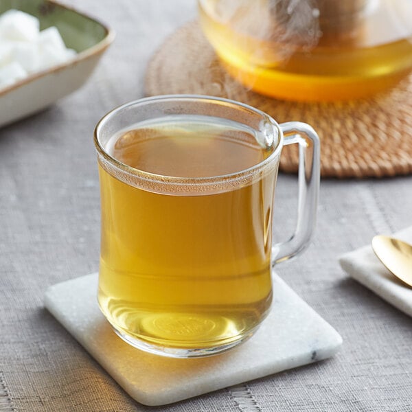 A glass mug of Davidson's Organic Anise Seeds tea on a coaster.