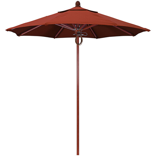 A red umbrella with a wooden pole.
