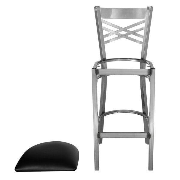 A steel black vinyl chair with a curved top.