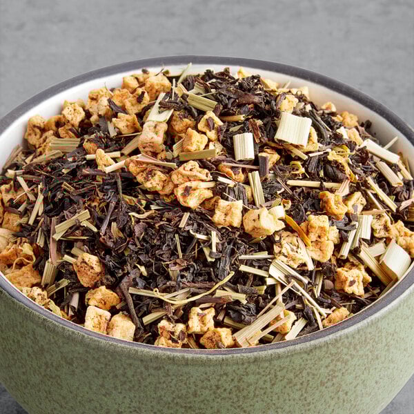 A bowl of Davidson's Organic Peach Apricot Essence Loose Leaf Tea with dried fruit and nuts.