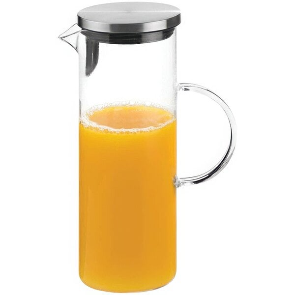 An APS glass carafe filled with orange liquid.