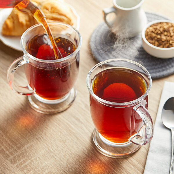 A close-up of a white mug filled with brown Davidson's Organic Yerba Mate tea.