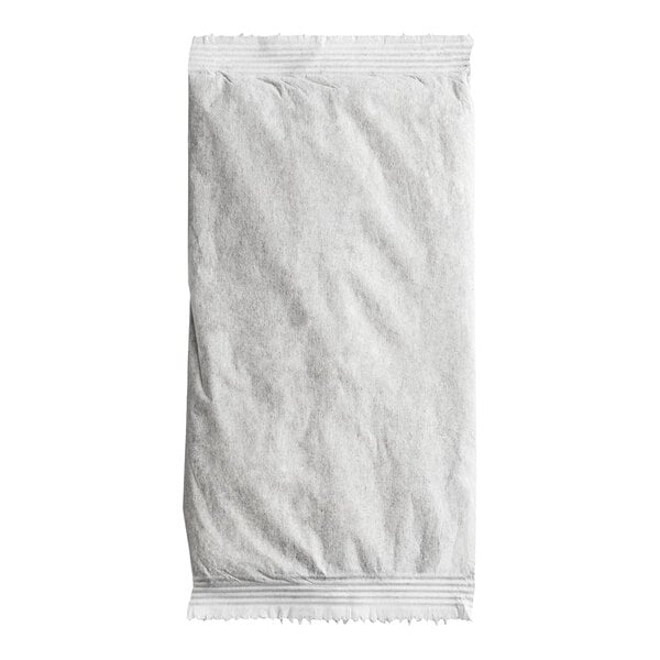 A sealed, rectangular white filter pack with a slightly crinkled texture, likely containing tea or a similar product.