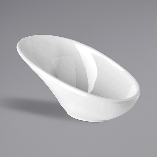 A white APS Minis melamine bowl with a curved edge on a gray surface.