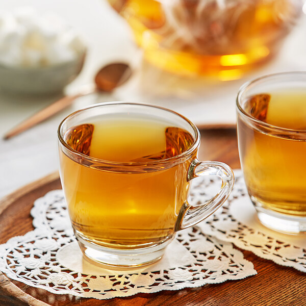 Two glass cups of Davidson's Organic Valentine Loose Leaf Tea on a table.