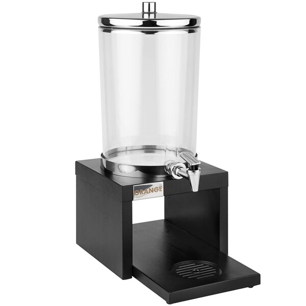 An APS Bridge glass beverage dispenser on a wood stand.