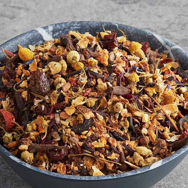 A bowl of Davidson's Organic Garden Harvest Herbal loose leaf tea on a table.