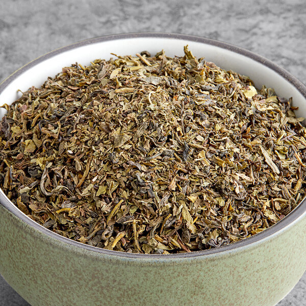 A bowl of Davidson's Organic Moroccan Green with Mint Loose Leaf Tea.